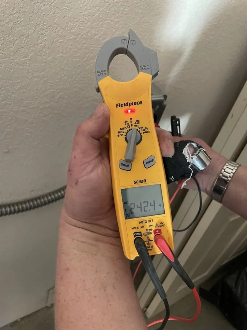 Voltage testing with clamp meter during Outlet Installation in Jenner